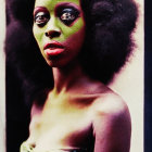 Woman with vibrant green and pink makeup and afro hair against grunge-style backdrop