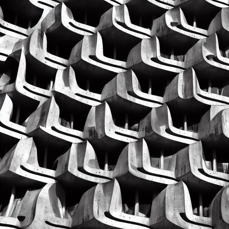 Monochrome abstract photo of building with wavy concrete balcony pattern