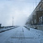 Snowy Abandoned Industrial Site with Dilapidated Buildings