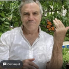 Person in White Shirt Surrounded by Butterflies in Garden Setting