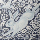 Detailed illustration of two blue rabbits amidst intricate floral pattern in blues, whites, and yellows.