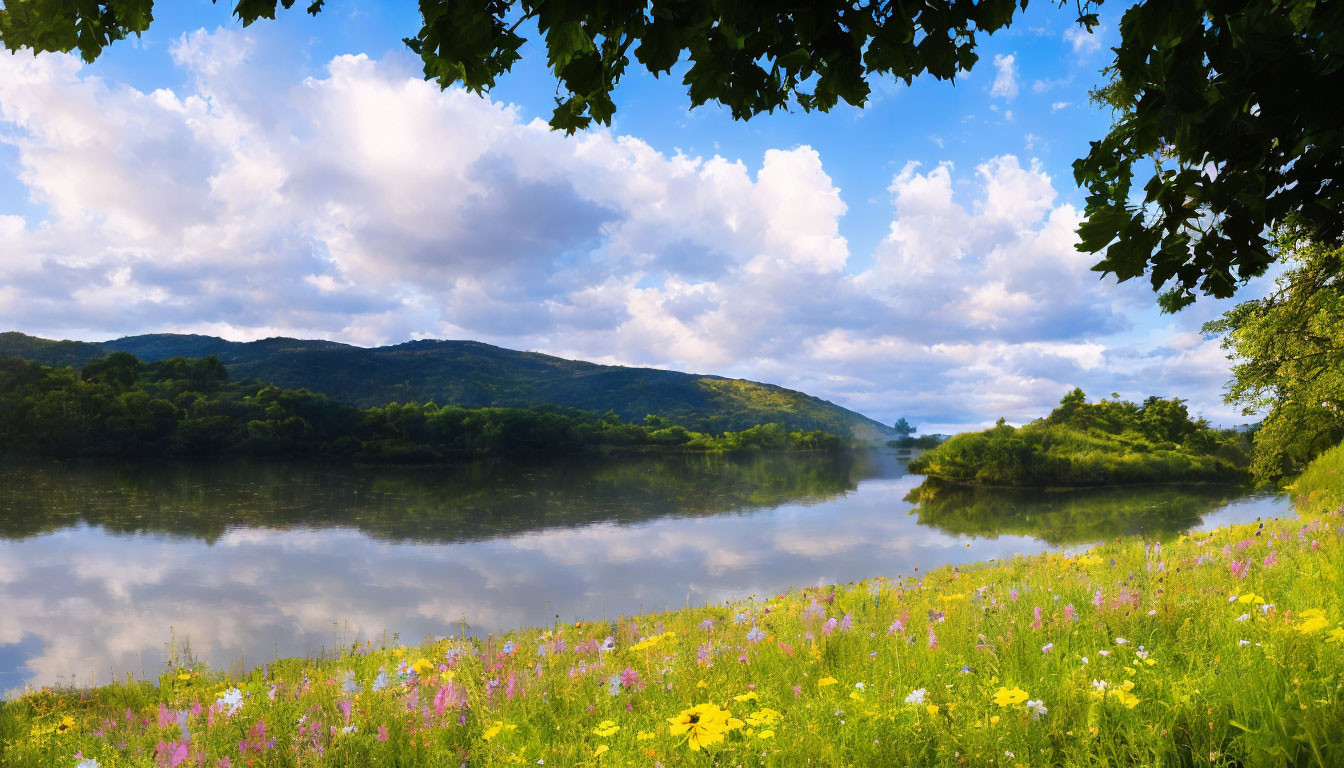 Tranquil river scene with green hills, wildflowers, and blue sky