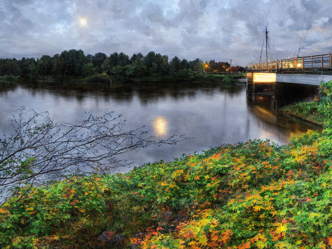 Tranquil river scene with autumn foliage and pedestrian bridge