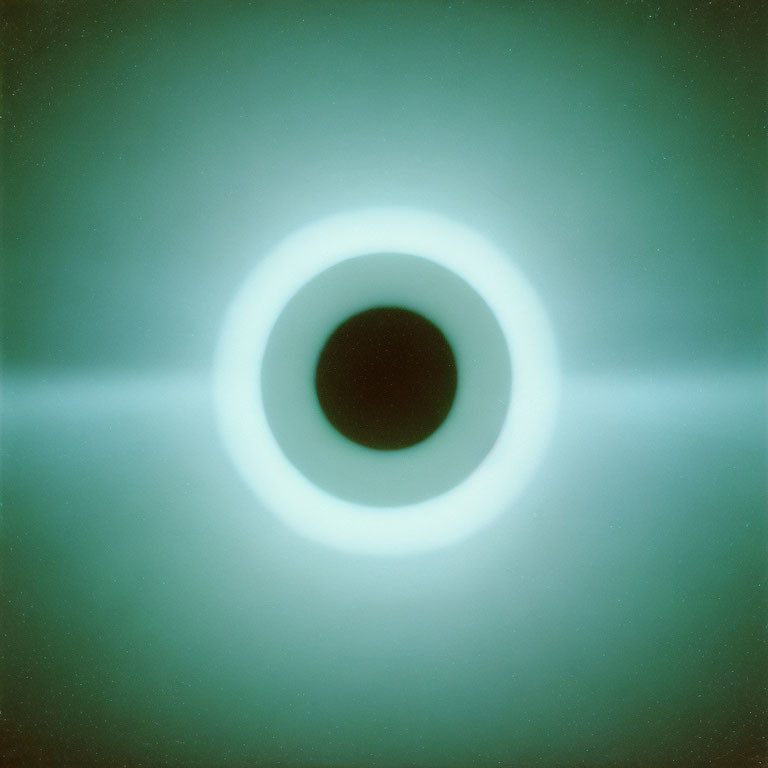 Green-hued image with black circle and white ring resemblance.