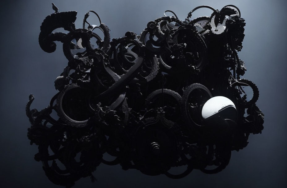 Assorted black metal objects with curved shapes and a white motorcycle helmet.