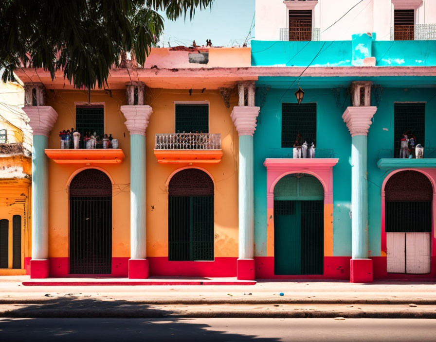 Vibrant old buildings with arches and balconies in colorful hues against blue sky