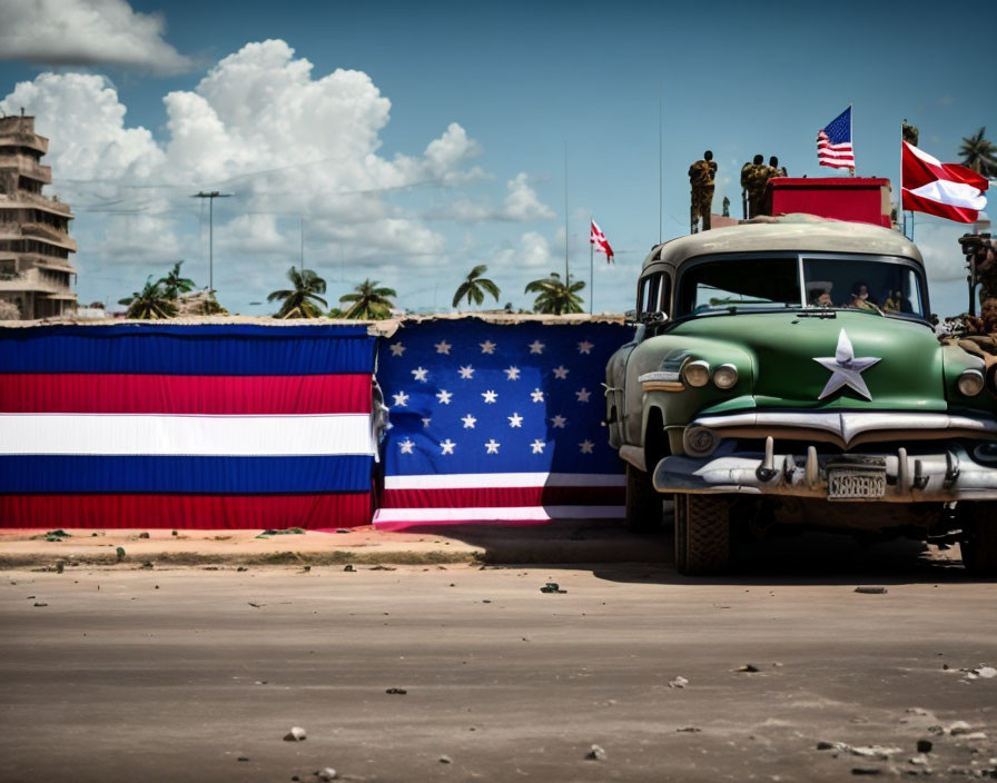 Vintage green car with white star passing Puerto Rican flag, people on building, clear sky