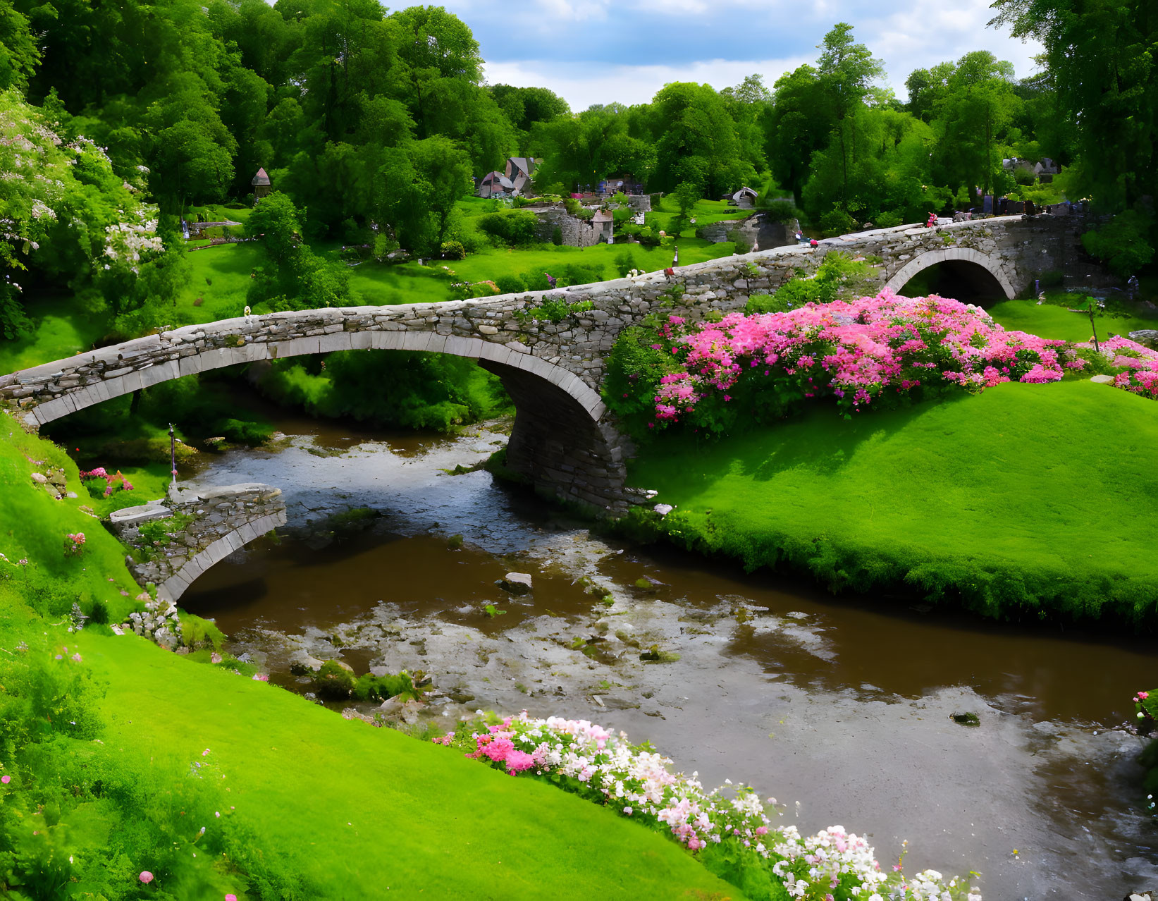 Tranquil landscape with ancient stone bridge, lush greenery, and pink flowers