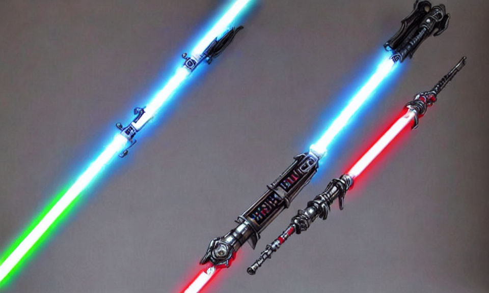 Three illuminated lightsabers with blue, green, and red blades on grey background