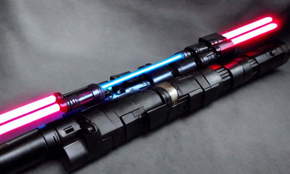 Illuminated Lightsabers: Blue and Red Blades Crossed on Dark Background