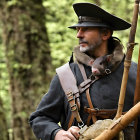 Man in historical clothing with musket and small animal in wooded area