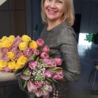 Blonde Woman with Bouquet in Sunlit Garden