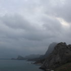 Misty Seascape with Towering Clouds and Rocky Shores