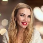 Blonde woman portrait with sparkling earrings on soft background