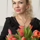 Blonde Woman in Black Dress with Red and Yellow Tulip Bouquet