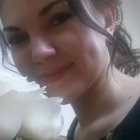 Woman with voluminous updo hair and bouquet of white flowers in soft lighting