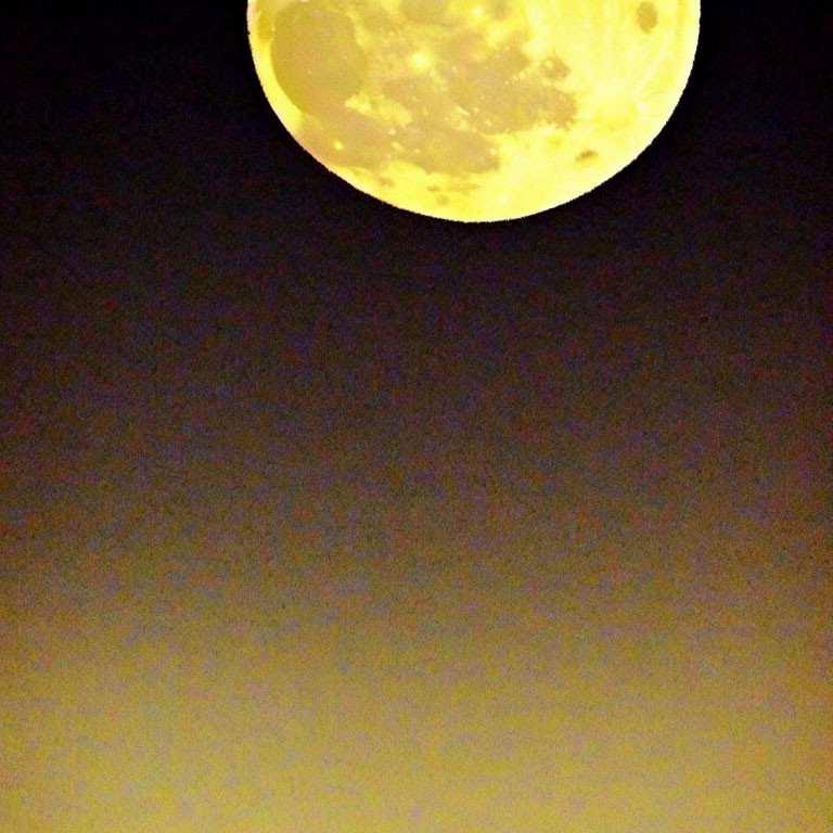 Bright full moon in dark sky with gradient to warm yellow.