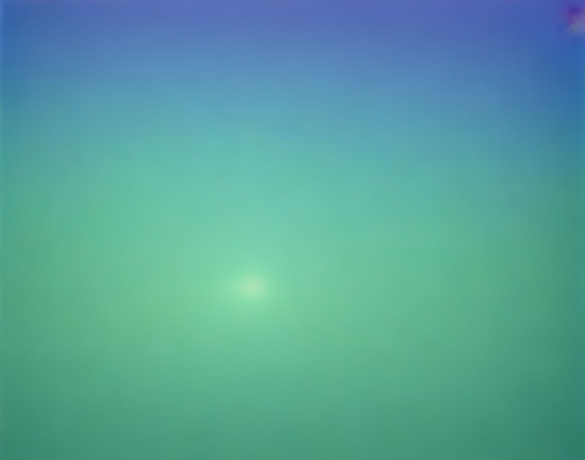 Blurred blue and green gradient with central bright spot