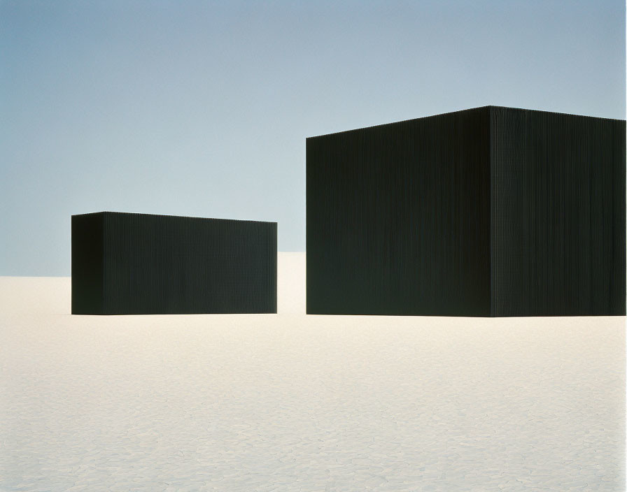 Black Cubes on White Salt Flat Under Blue Sky