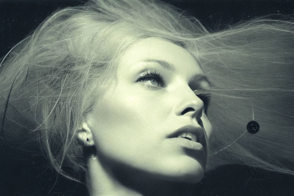 Monochrome portrait of woman with flowing hair and serene expression