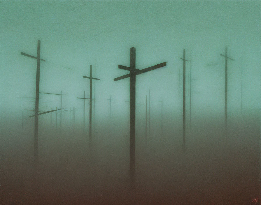 Misty Cross Silhouettes in Eerie Green Atmosphere