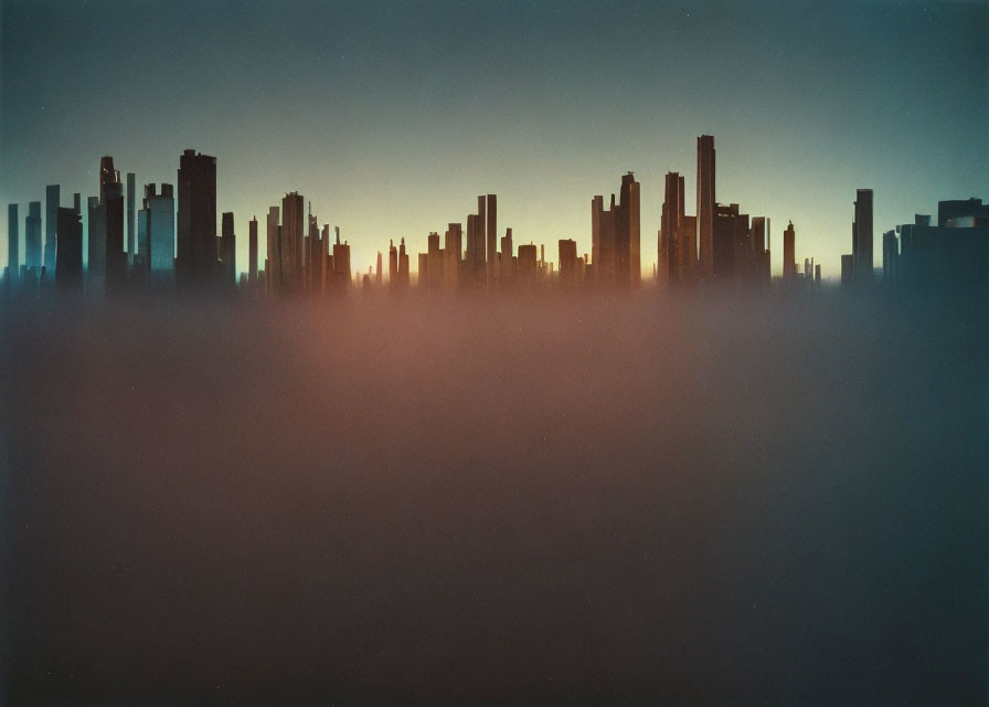 City skyline silhouette at twilight with orange and blue sky and mist-covered buildings