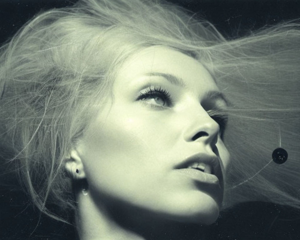 Monochrome portrait of woman with flowing hair and serene expression