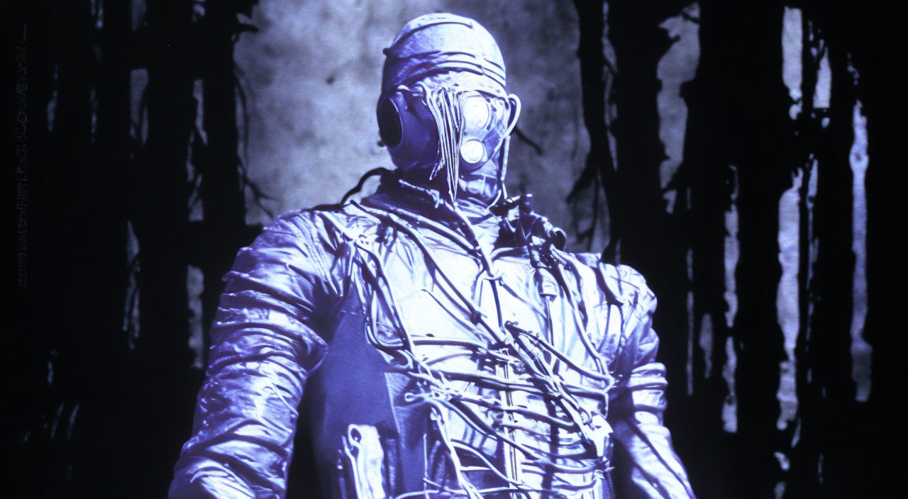 Futuristic figure in blue light with wires and helmet on dark background