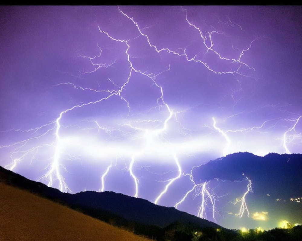 Dramatic lightning storm over mountainous landscape