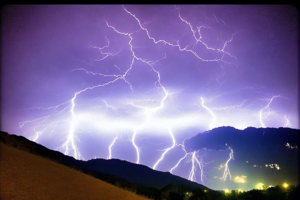 Dramatic lightning storm over mountainous landscape