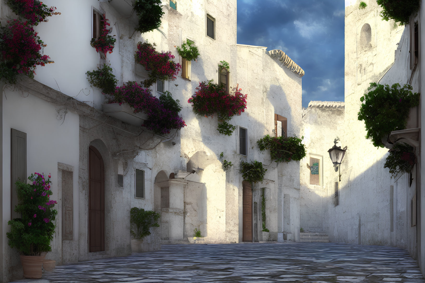 Charming cobblestone street with white buildings and pink bougainvillea