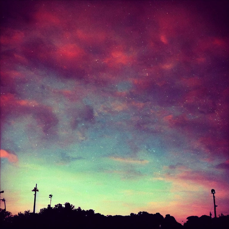 Vibrant Dusk Sky with Purple and Pink Hues over Silhouetted Streetlights