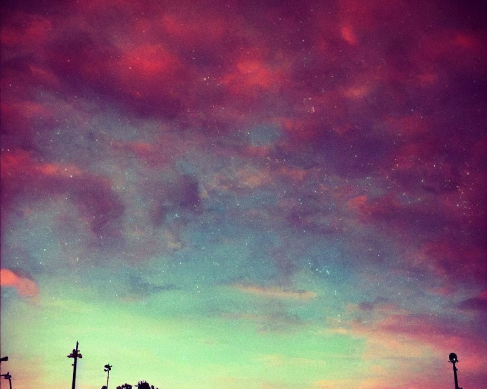 Vibrant Dusk Sky with Purple and Pink Hues over Silhouetted Streetlights