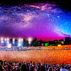 Crowded concert scene under colorful cosmic sky