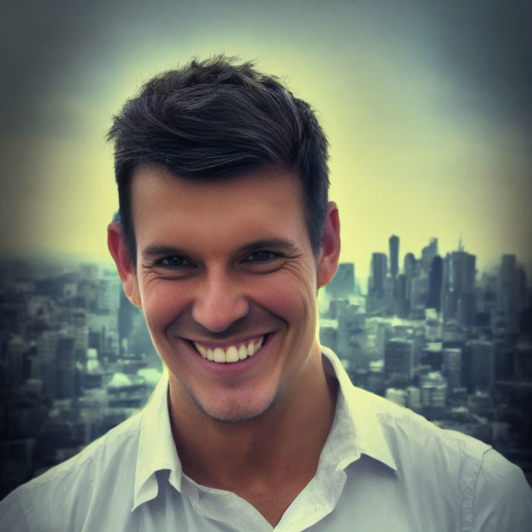 Dark-haired man in white shirt against blurry city skyline