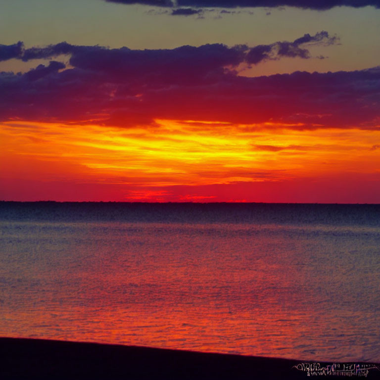 Tranquil Sunset Scene with Red and Orange Reflections