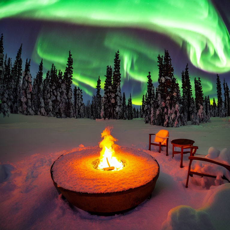 Majestic aurora borealis over snowy landscape with fire pit and chairs