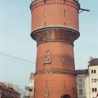 Person walking towards grand cylindrical building in pastel cityscape