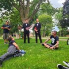 Pair practicing martial arts with sculpted dragons in green park