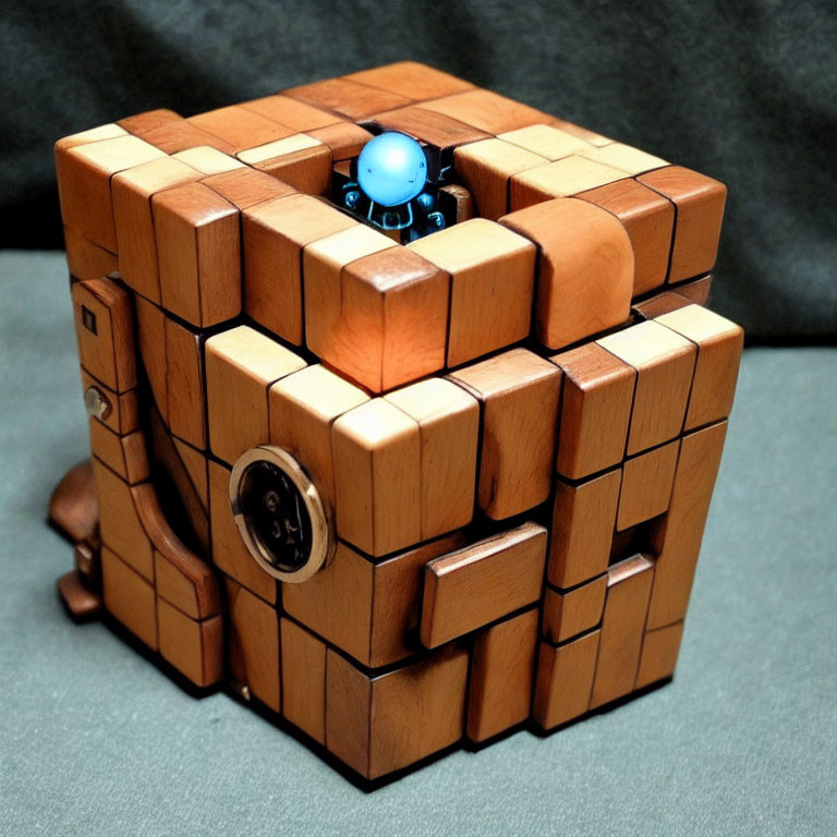 Wooden Puzzle Cube with Blue Figurine on Dark Background