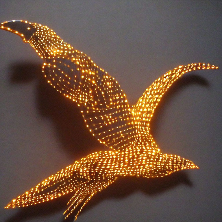 Bird in Flight Outline Illuminated by Warm-Toned Light Bulbs