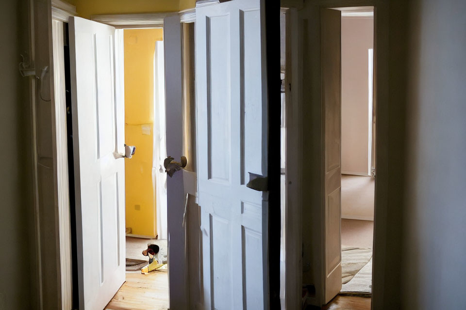 White Doors Open to Yellow and Pink Rooms