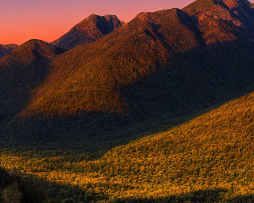 Mountainous Landscape at Sunset with Orange and Purple Sky