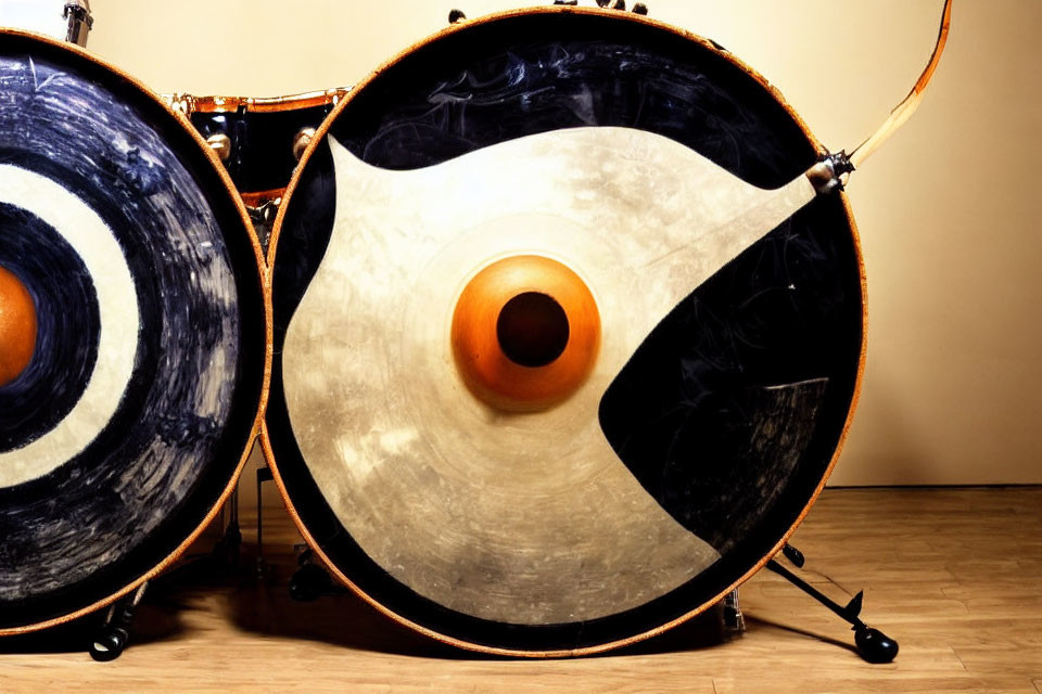 Large Bass Drums with Blue and Black Circular Patterns on Wood Floor