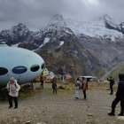 Majestic UFO over mountain landscape with river and cabin