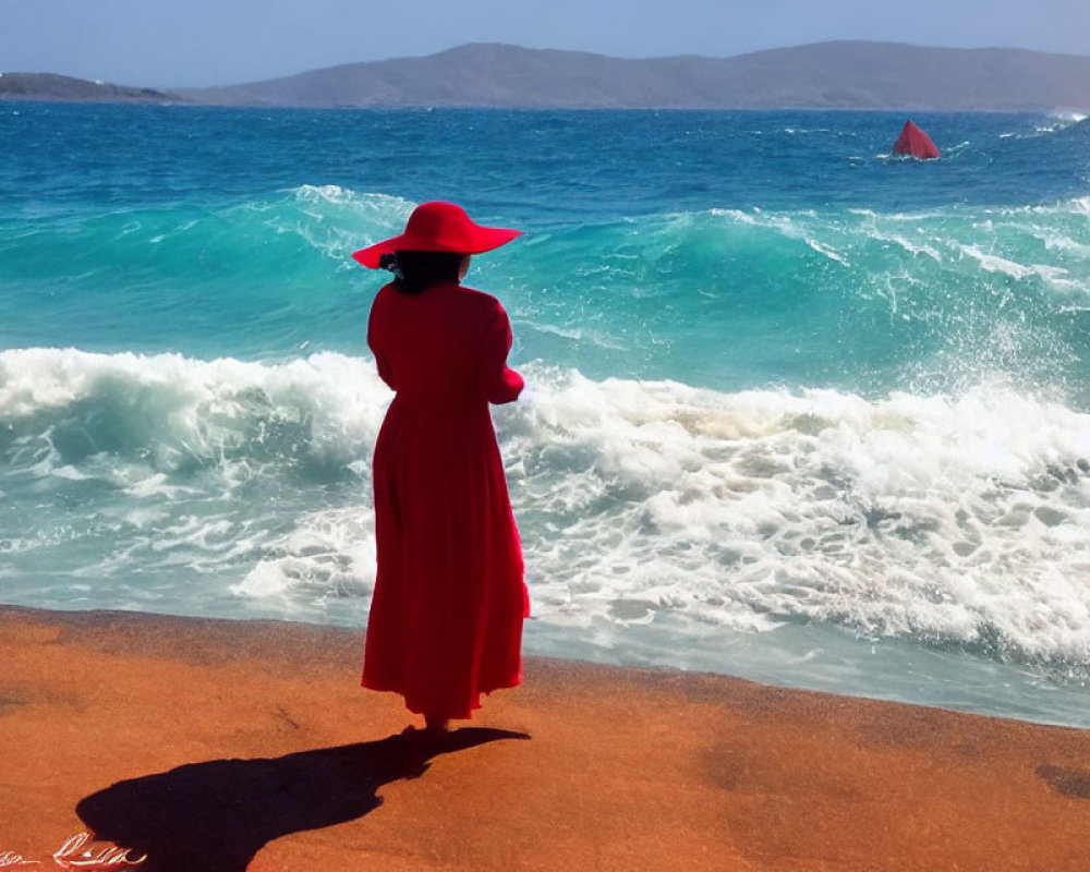 Woman in red dress and hat on beach watching waves and sailboat in the distance