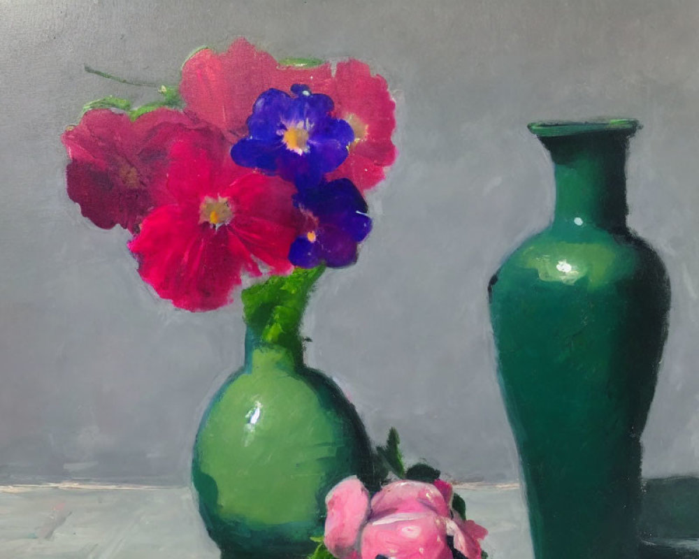 Colorful red and purple flowers in green glass vase on muted background