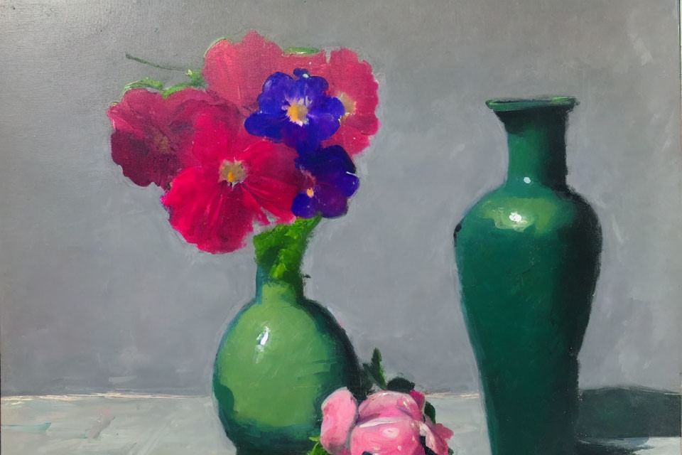 Colorful red and purple flowers in green glass vase on muted background