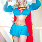 Muscular person in Supergirl costume flexing fists confidently