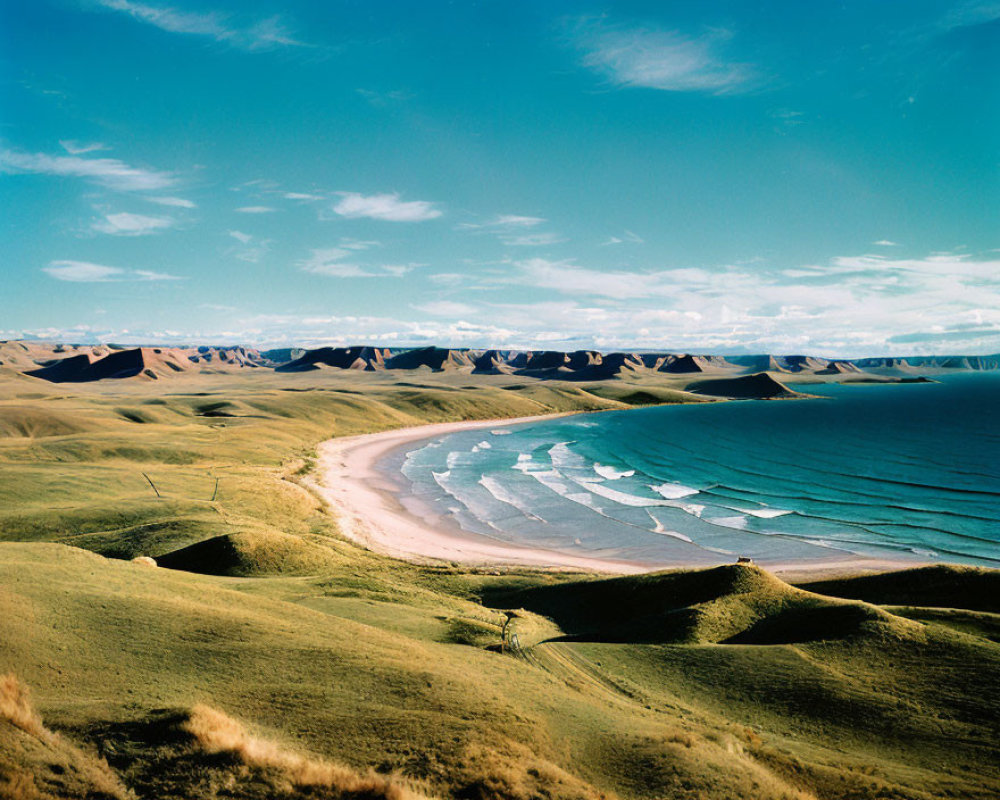 Serene beach with clear blue waters and lush green hills